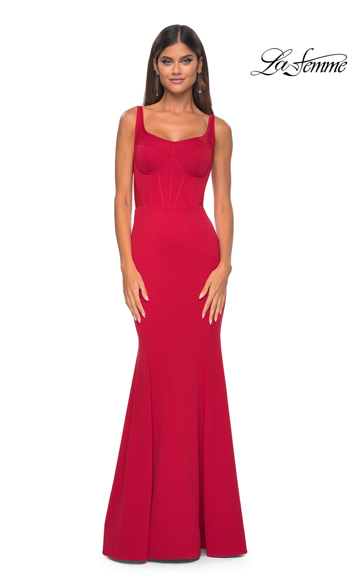 A woman models the La Femme Lace-Up Sheer Back Long Prom Dress 32268, a fitted sleeveless red gown with a corset bodice, against a white background. The
